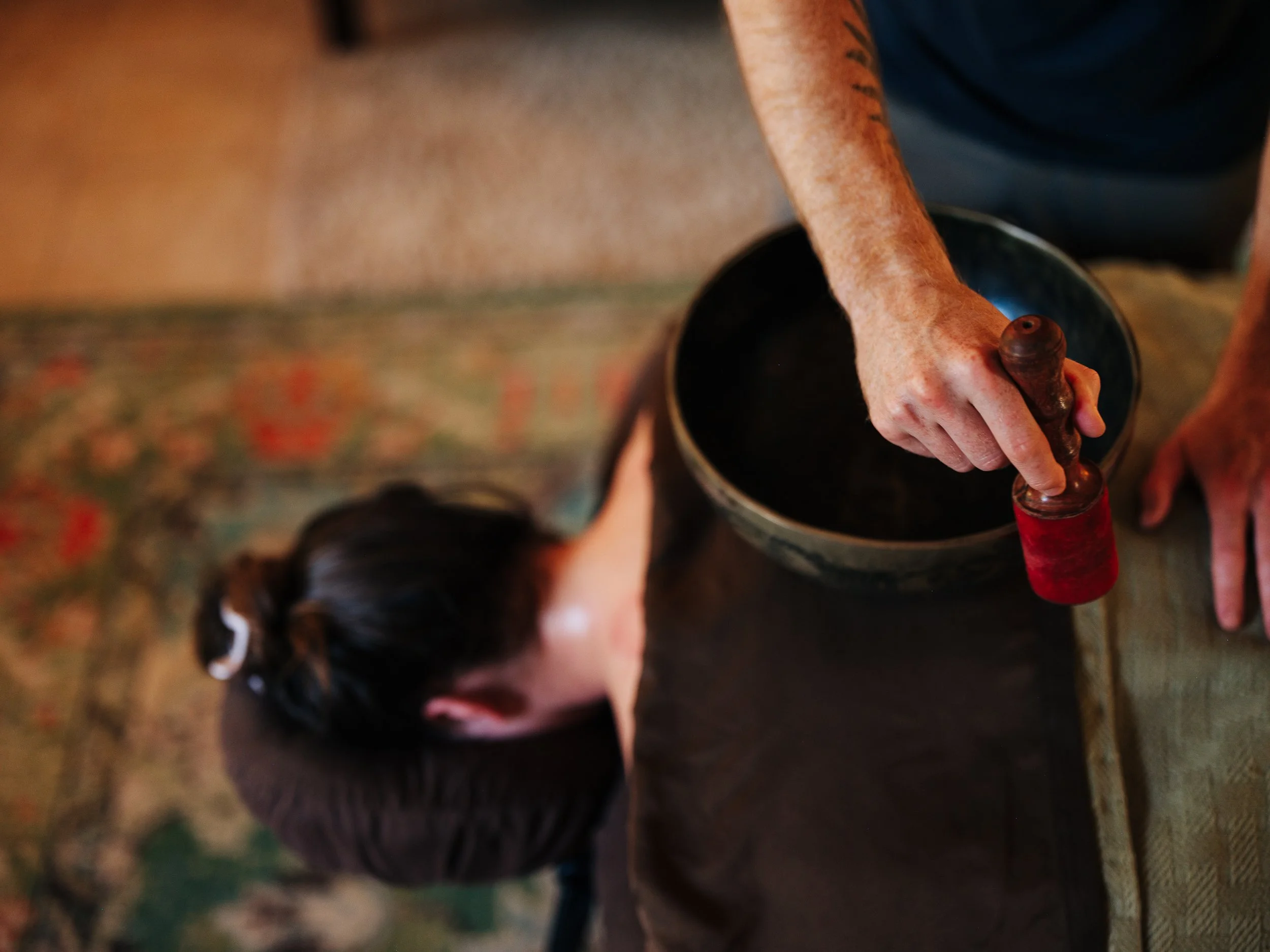 Sound healing with singing bowl during massage session in Asheville NC