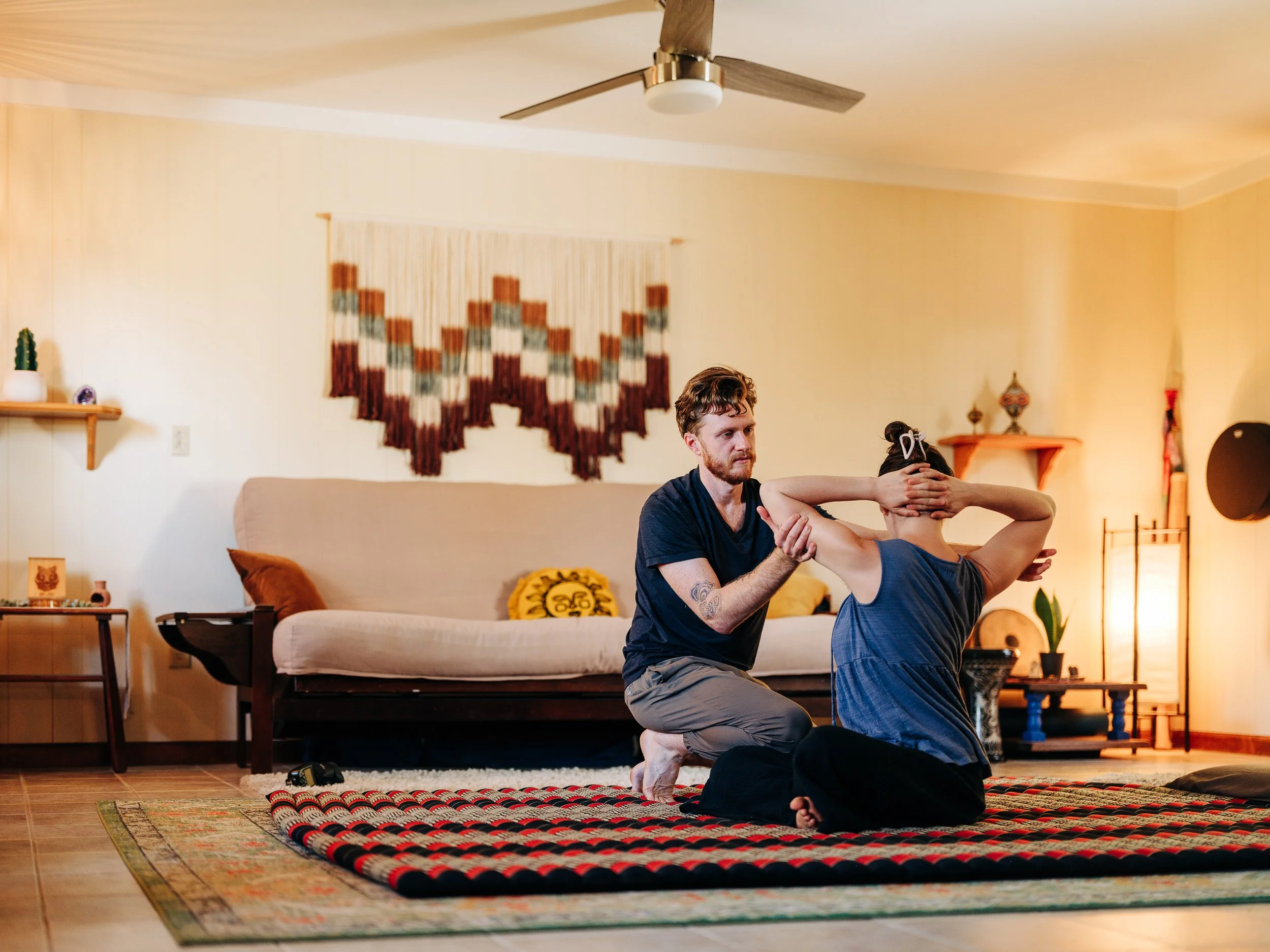 Wide shot of Thai massage in the warm studio